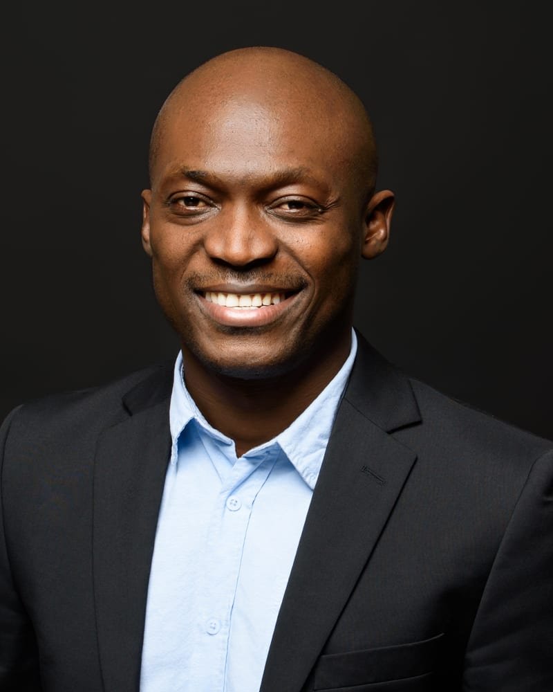 Wilfrid Ngouffo in a suit, smiling